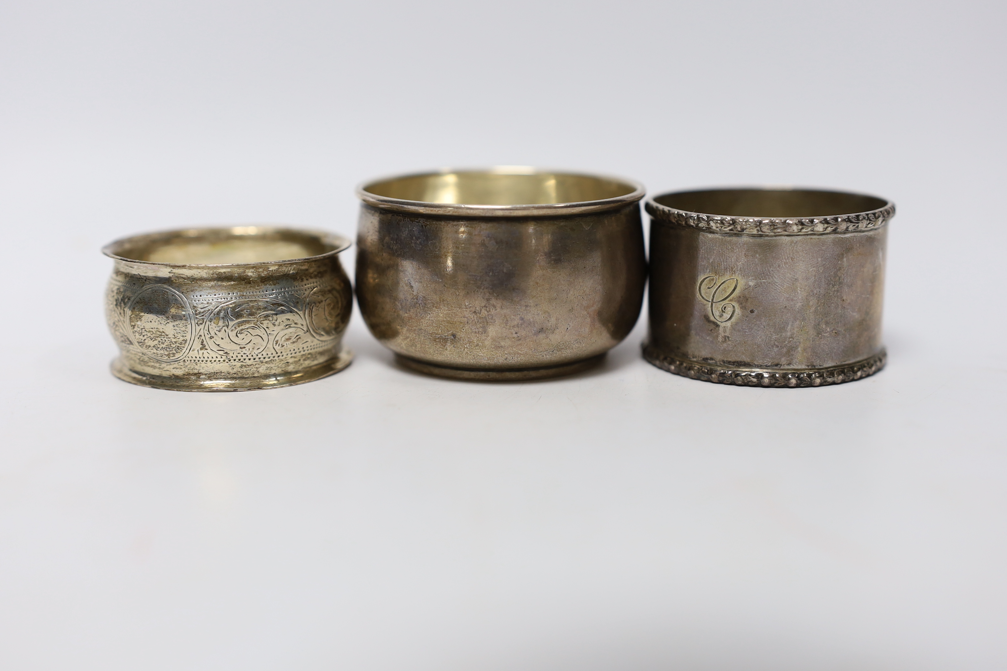 Seven assorted silver napkin rings and a small silver bowl